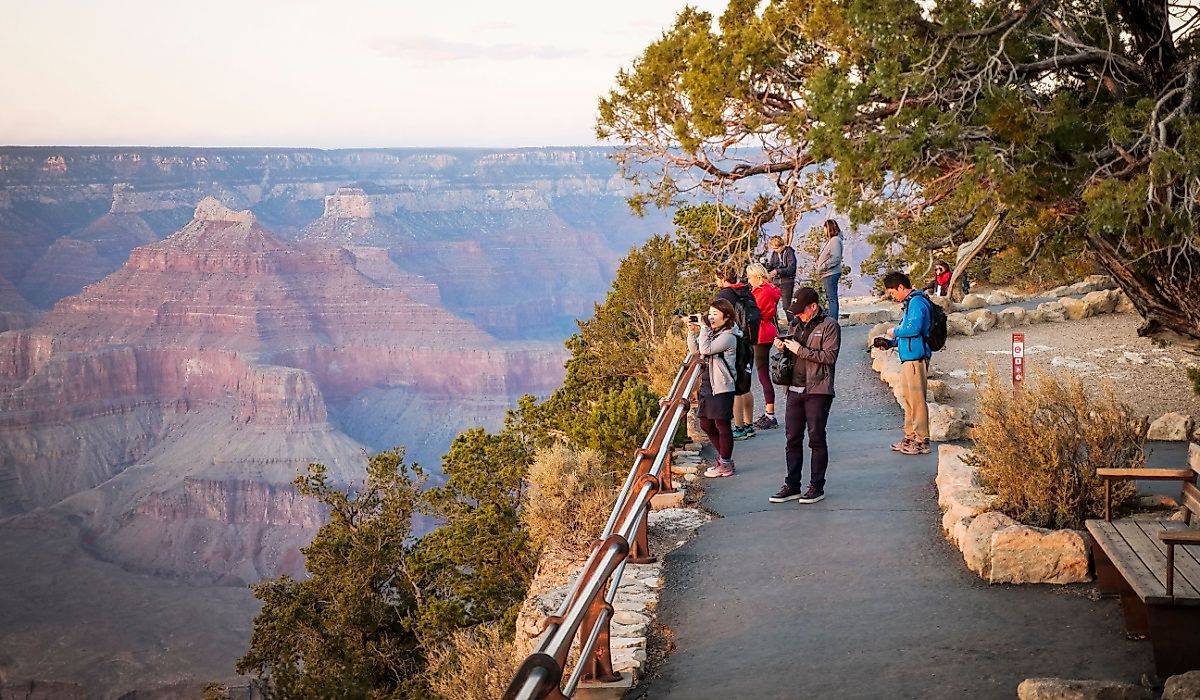 Tourists watch the sunset of the Grand Canyon South Rim. Image credit hafakot via Shutterstock.